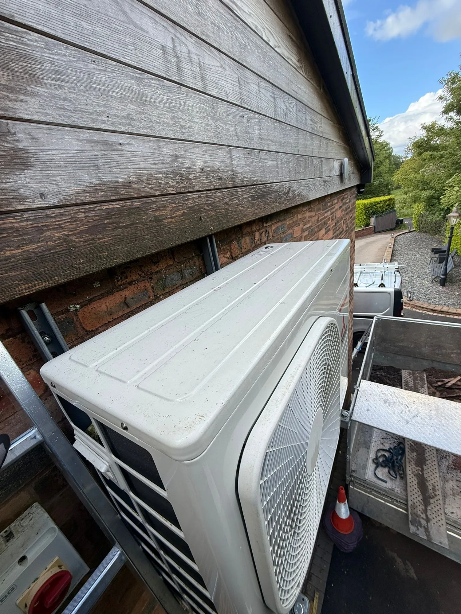 Outdoor air conditioning unit accessed for servicing and maintenance by Aervue